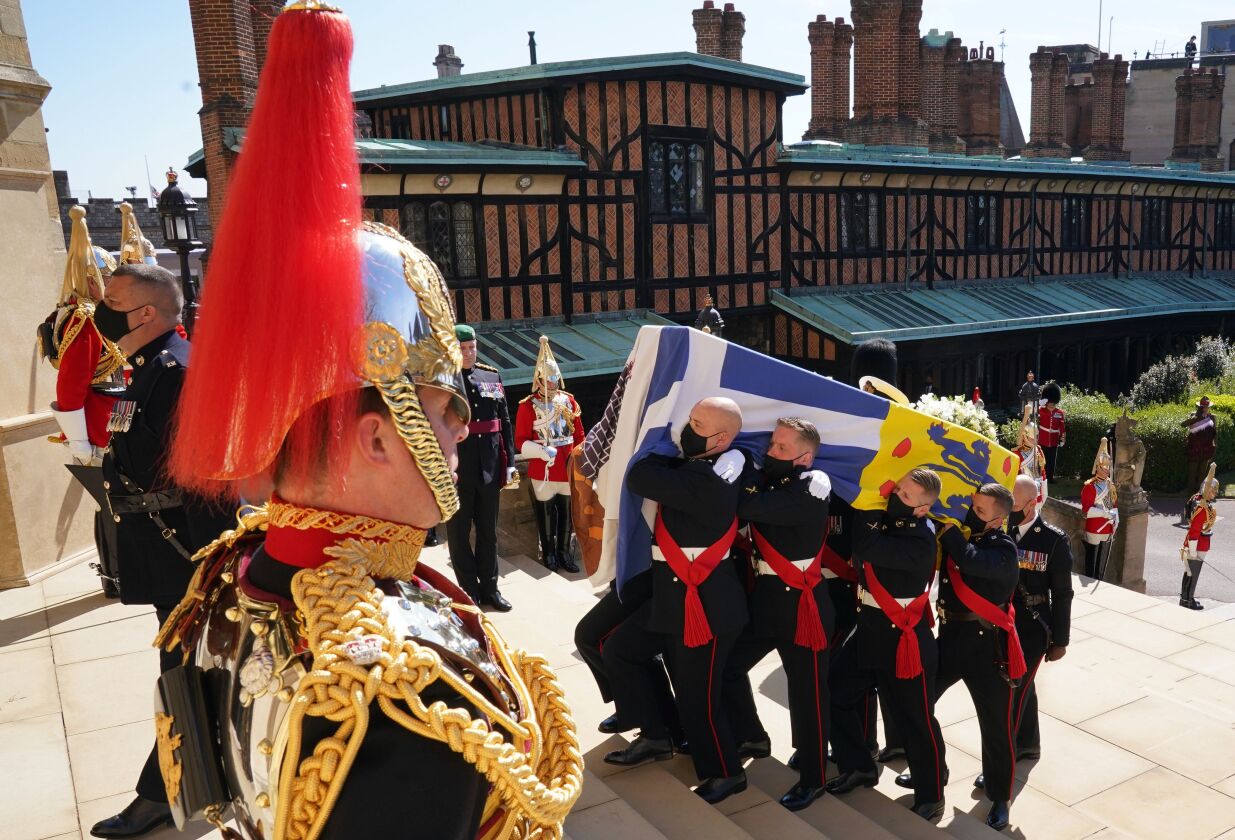 The coffin is carried up the steps of St George’s Chapel during the procession of Britain Prince Philip’s funeral at Windsor Castle, Windsor, England, Saturday April 17, 2021.